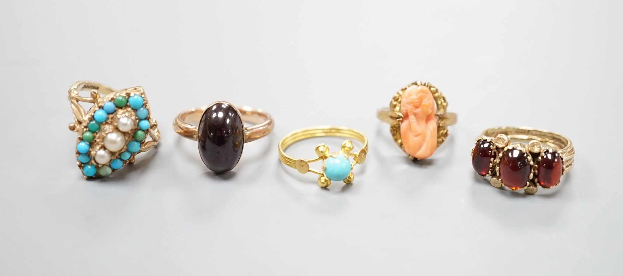 Three assorted modern 9ct gold and gem set ring including turquoise and seed pearl, gross 11.2 grams, a 10k and coral set ring, gross 2.7 grams and a yellow metal and turquoise set ring, gross 1.3 grams.